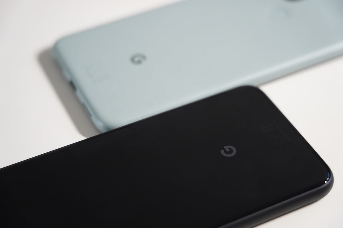 a close up of two cell phones on a table