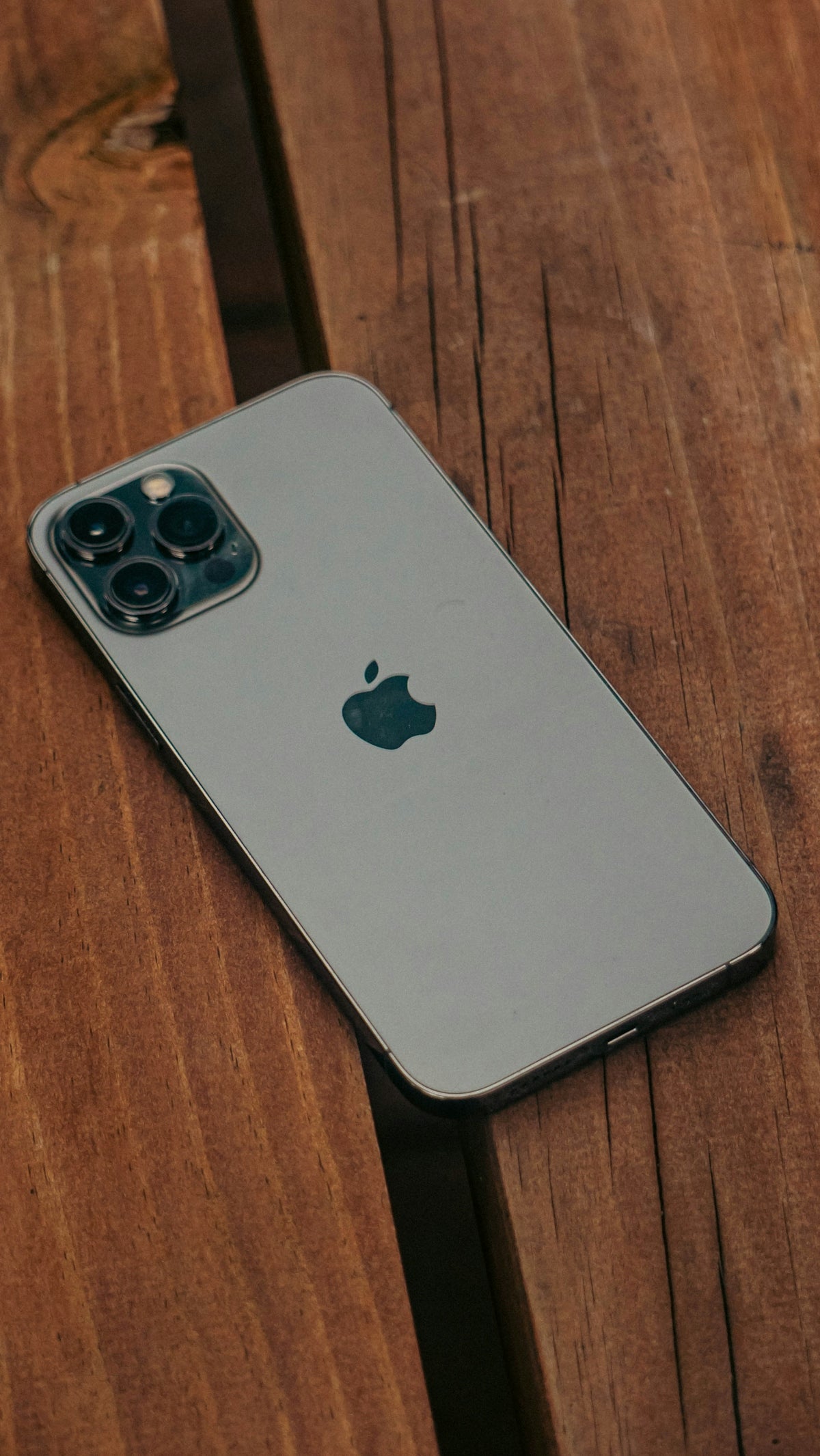 a close up of an iphone on a wooden table