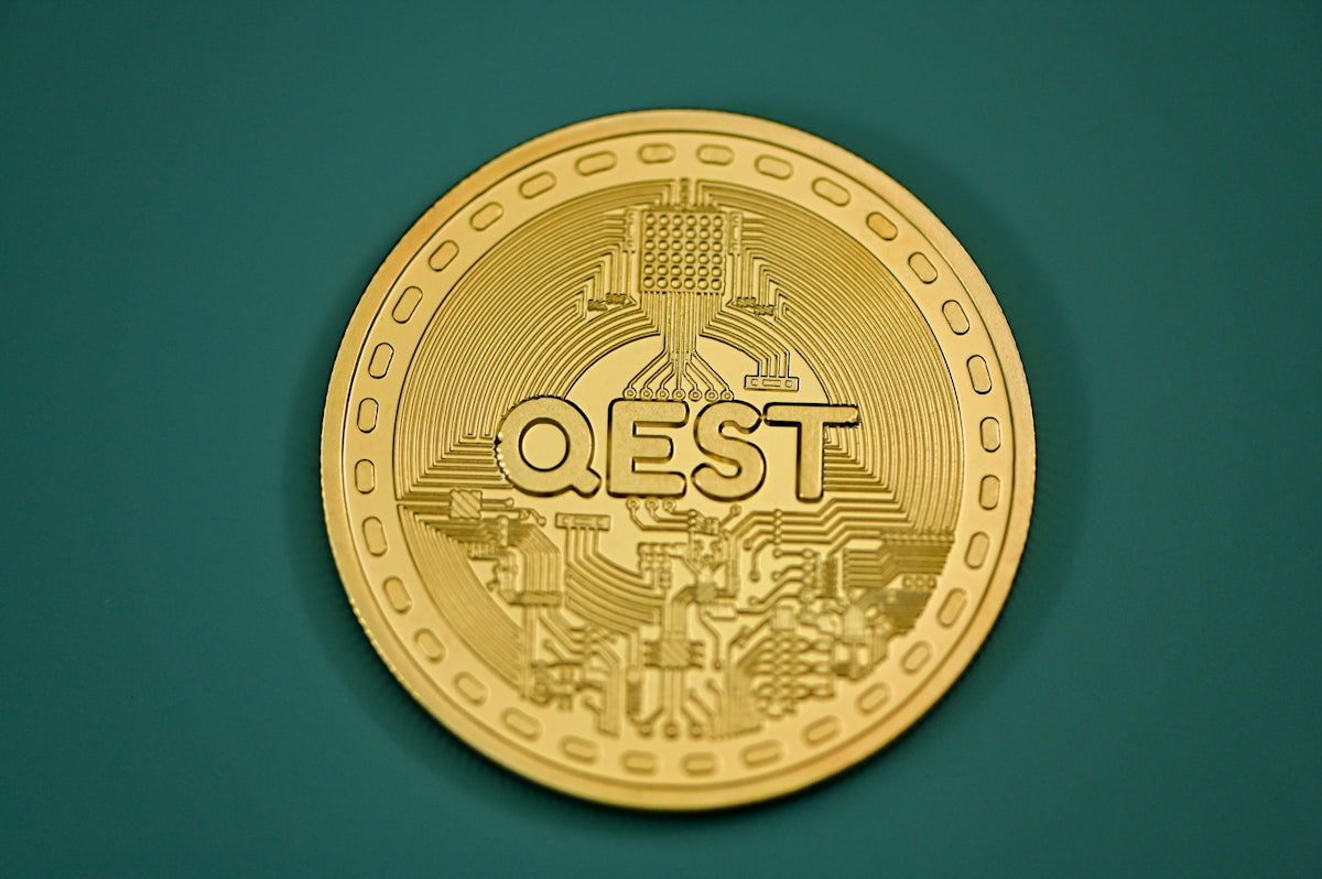 a close up of a gold coin on a green surface